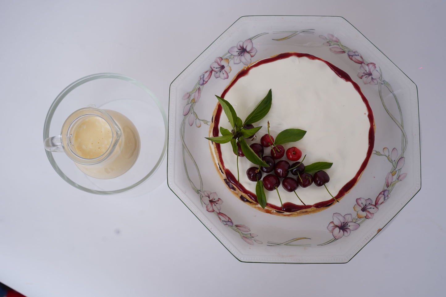 Cherry Shortbread Dessert: Layers of buttery shortbread biscuit, lathered with fresh cream and juicy cherries, topped with a beautifully arranged cherry layer and a delicate caramel web. Served with a box of homemade custard for an extra touch of indulgence.