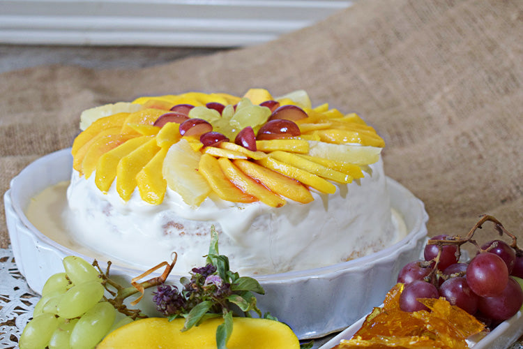 Mixfruit Tres Leches Cake: Light sponge soaked in a rich Tres Leches blend, topped with a medley of fresh fruits and smooth cream.
