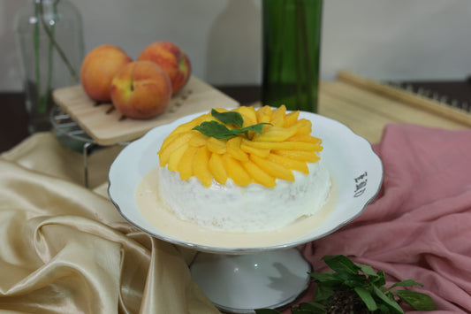 Peach and Cream Tres Leches Cake: Soft sponge soaked in a Tres Leches blend, topped with fresh peaches and smooth cream.
